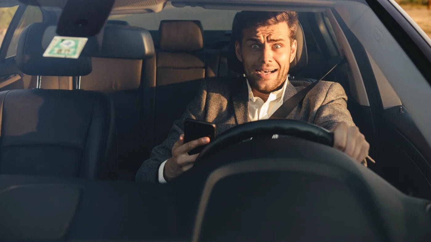 Portrait of a scared young business man in a car